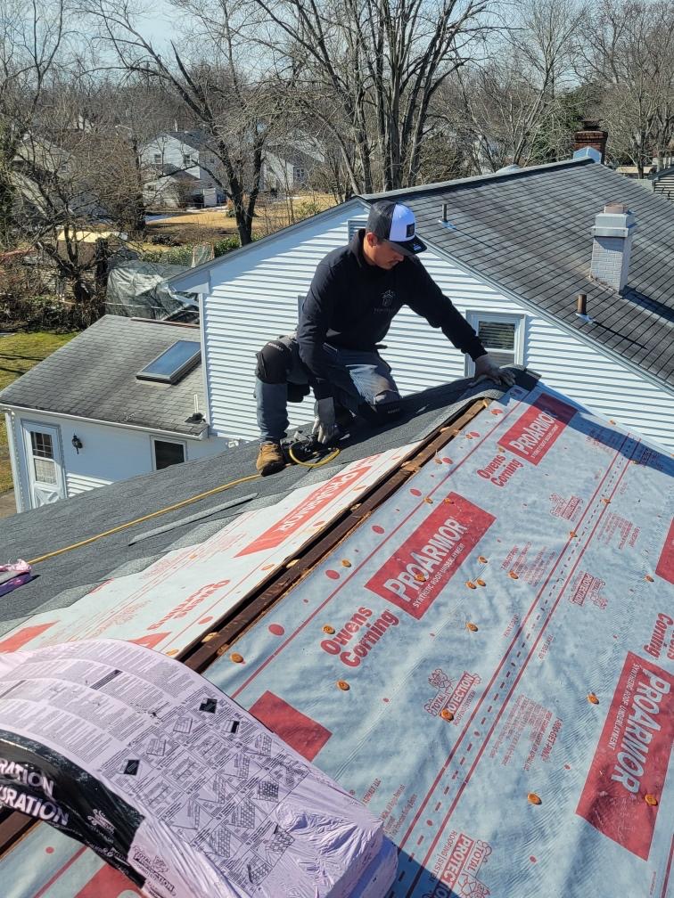 Workers installing shingles